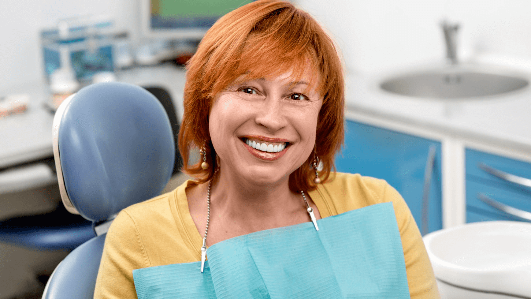 red-haired woman smiling at de